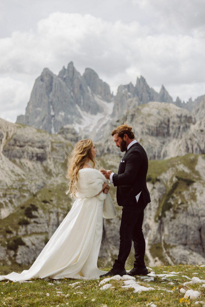 Couple at the iconic Cadini di Misurina viewpoint during a sunrise Dolomites elopement.