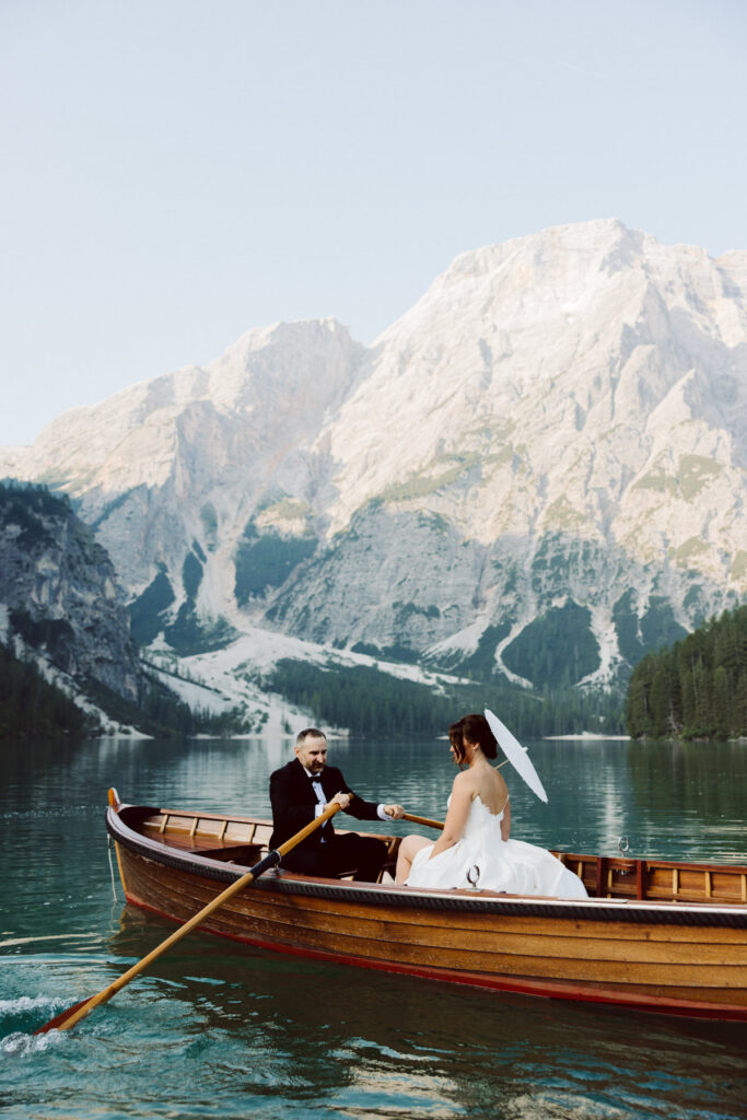 Couple exchanging private vows surrounded by the mountains during their intimate Dolomites wedding at Lago Di Braise.