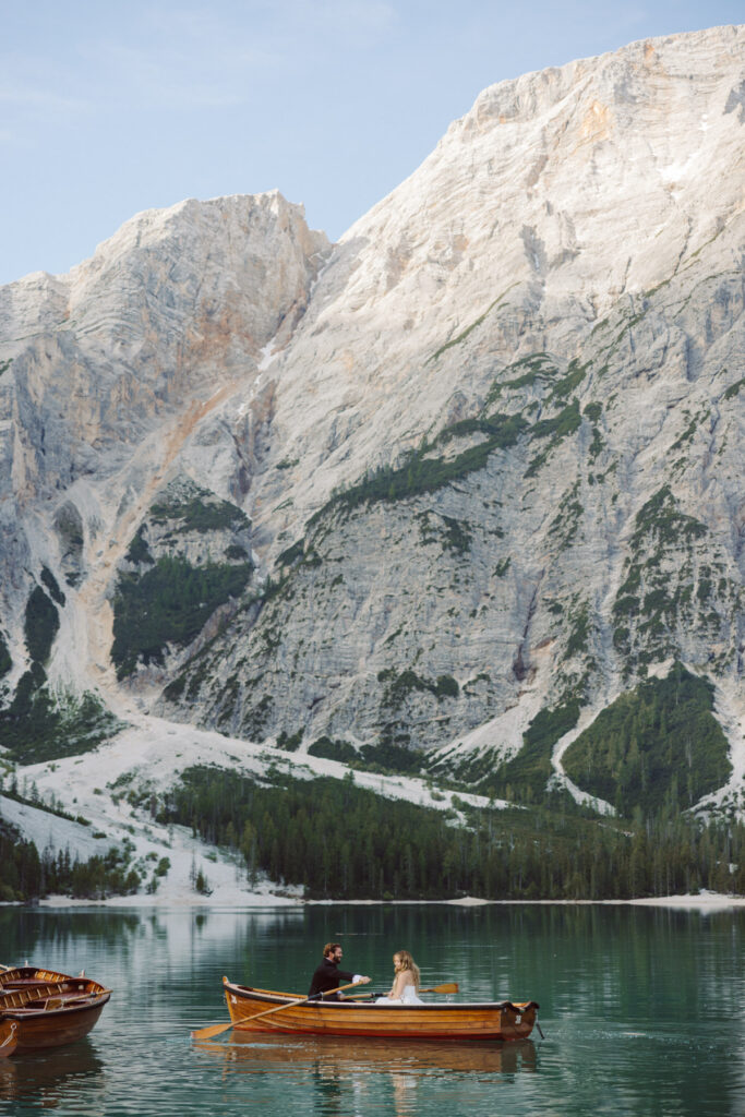 Bride and groom overlooking the turquoise waters of Lago di Sorapis during a Dolomites adventure wedding.