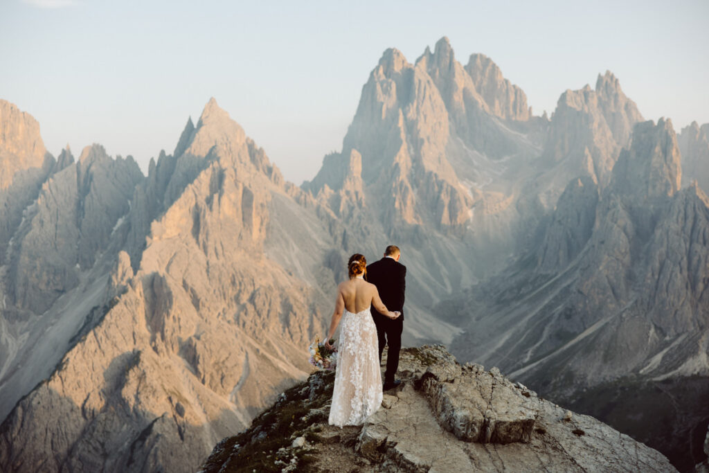 Couple at the iconic Cadini di Misurina viewpoint during a sunrise Dolomites elopement.