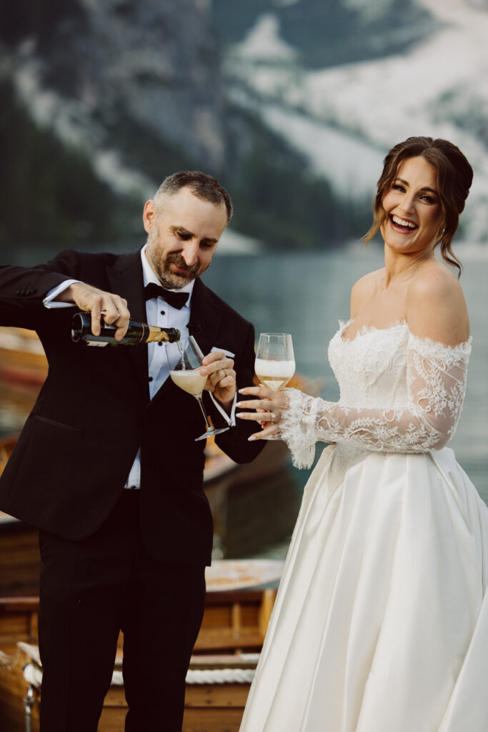 Couple exchanging private vows surrounded by the mountains during their intimate Dolomites wedding at Lago Di Braise.