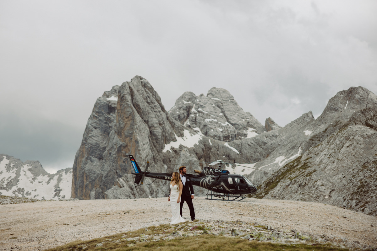 Couple embracing during a sunrise Dolomites elopement with dramatic mountain views in the Italian Alps.